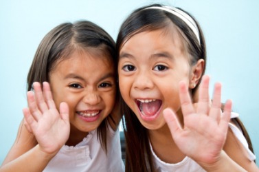 Two little girls wave. Two little girls wave.