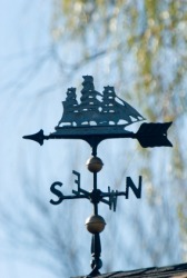 A weather vane in the shape of a ship. A weather vane in the shape of a ship.
