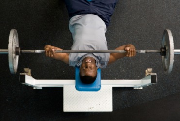 A weightlifter on a bench press. A weightlifter on a bench press.
