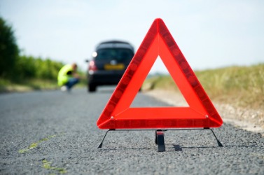 This red triangle warns of a disabled car ahead. This red triangle warns of a disabled car ahead.