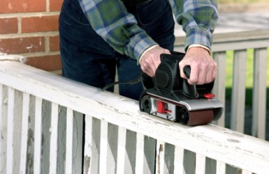 A man fixes the railing of his porch. A man fixes the railing of his porch.