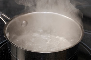 Water vapor rising of a pan of boiling water. Water vapor rising of a pan of boiling water.