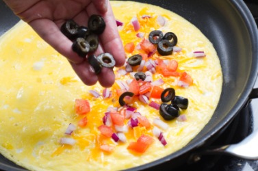 Adding additional olives. Adding additional olives.