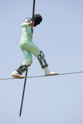 A man balancing on a tight rope. A man balancing on a tight rope.