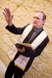 A priest offers a benediction. A priest offers a benediction.