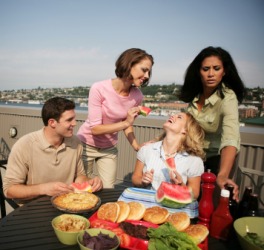 Entertaining friends at a rooftop picnic. Entertaining friends at a rooftop picnic.