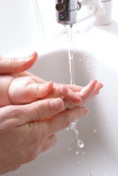 Gentle is how this mother washes her baby's hand. Gentle is how this mother washes her baby's hand.