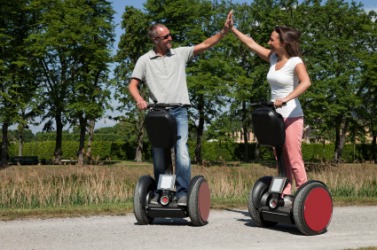Two people riding Segways. Two people riding Segways.
