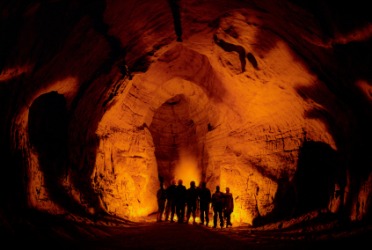 A group explore the inside of a cave. A group explore the inside of a cave.