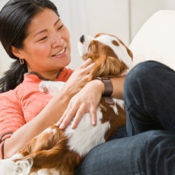 This woman's pet is a dog. This woman's pet is a dog.