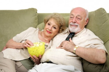 A couple relax in front of the tv. A couple relax in front of the tv.