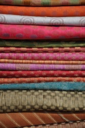 A stack of different textiles. A stack of different textiles.