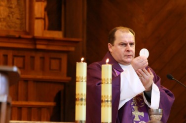 A Catholic priest observes the rite of communion. A Catholic priest observes the rite of communion.