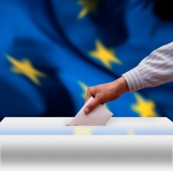 A man casts his vote during an election. A man casts his vote during an election.