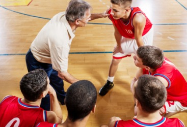 A coach encouraging his team. A coach encouraging his team.