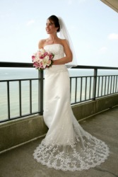 A woman poses in her wedding gown. A woman poses in her wedding gown.