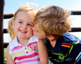 A little girl receives kisses. A little girl receives kisses.