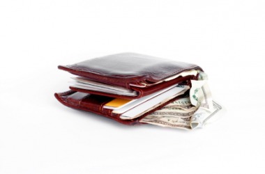 A billfold containing paper money and cards. A billfold containing paper money and cards.