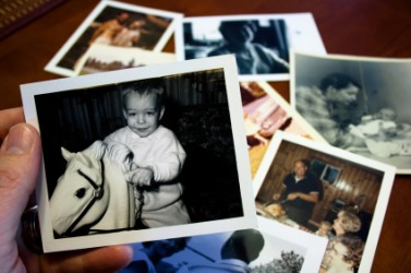 A person looks at old photos. A person looks at old photos.