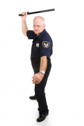 A billy, or billy club, in the hand of a policeman. A billy, or billy club, in the hand of a policeman.