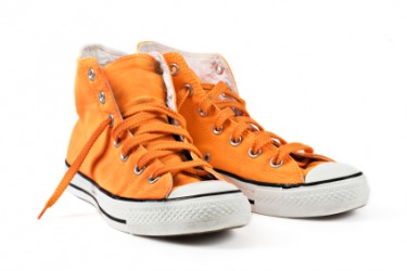A pair of orange shoes. A pair of orange shoes.