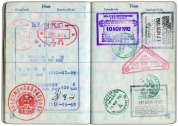 Many visas stamped on a passport. Many visas stamped on a passport.