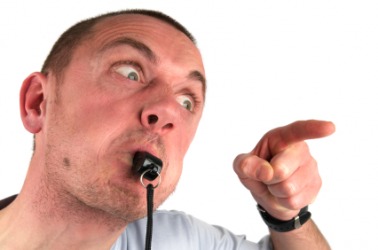 A man blows a whistle. A man blows a whistle.