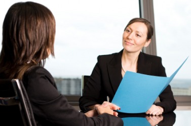 A woman has a conversation with her boss. A woman has a conversation with her boss.