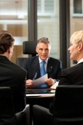 A couple in consultation with their lawyer. A couple in consultation with their lawyer.