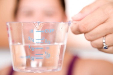 A woman tries to get an exact measurement. A woman tries to get an exact measurement.