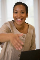 This woman greets you with a smile and a handshake. This woman greets you with a smile and a handshake.