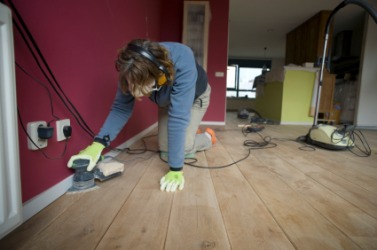 A sander is being used to level out this floor. A sander is being used to level out this floor.