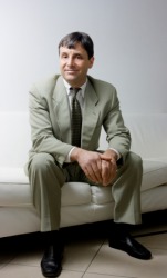 A man sitting on a sofa. A man sitting on a sofa.