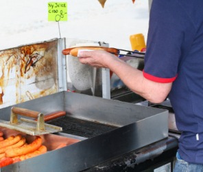 A hot dog vender. A hot dog vender.