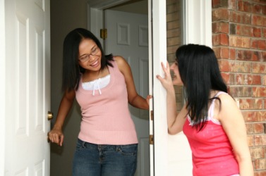 A woman welcomes a visitor. A woman welcomes a visitor.