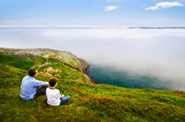 Father and son enjoy a beautiful vista. Father and son enjoy a beautiful vista.