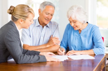 A couple consult with their accountant. A couple consult with their accountant.