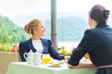 Two women enjoy a business luncheon. Two women enjoy a business luncheon.
