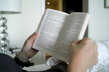 A person reading a novel. A person reading a novel.