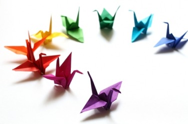 A rainbow of origami cranes. A rainbow of origami cranes.