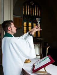 A priest celebrates mass. A priest celebrates mass.