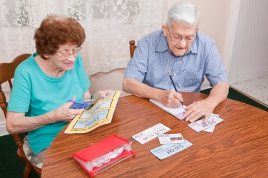 A couple being frugal by clipping coupons. A couple being frugal by clipping coupons.