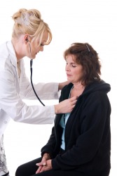 A doctor checks a woman's respiration. A doctor checks a woman's respiration.
