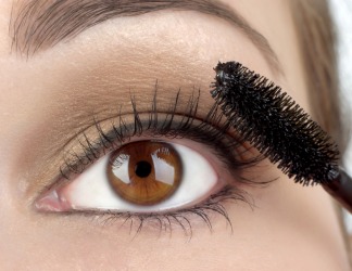 A woman uses make up to enhance her eyes. A woman uses make up to enhance her eyes.