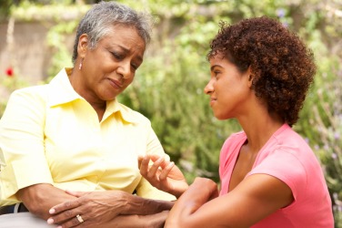 A woman gives solace to a friend. A woman gives solace to a friend.