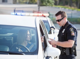 A person being cited with a speeding ticket. A person being cited with a speeding ticket.