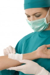 A doctor applies pressure to this bandage. A doctor applies pressure to this bandage.