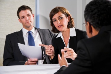 A business woman tries to persuade her coworkers. A business woman tries to persuade her coworkers.