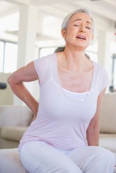 This woman suffers from chronic back pain. This woman suffers from chronic back pain.