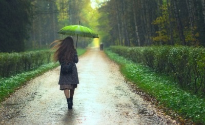 A woman takes a walk despite the rain. A woman takes a walk despite the rain.